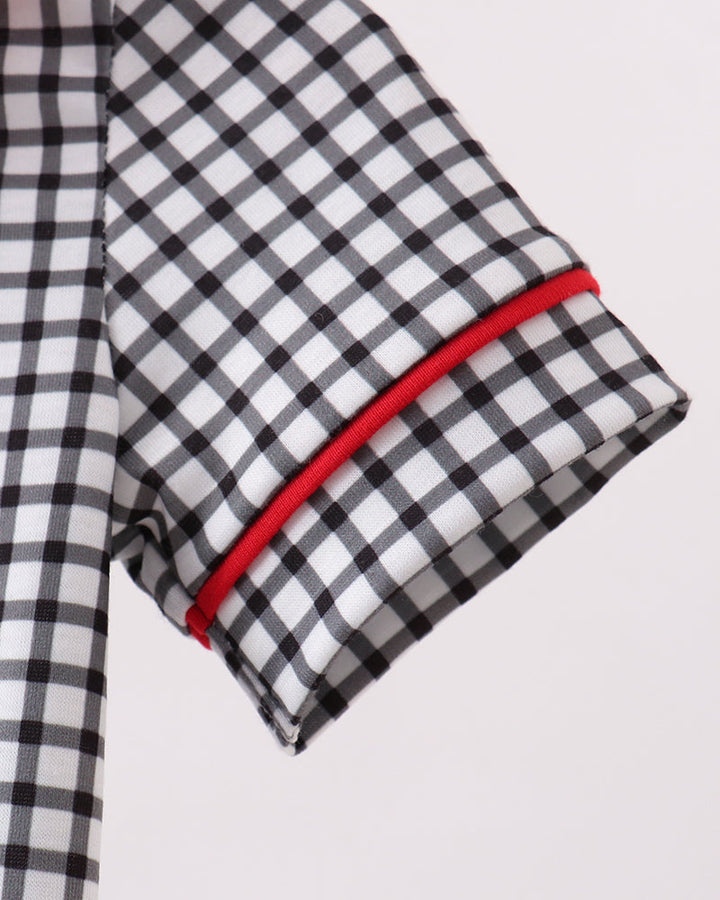 Black and white checkered fabric with red trim on a light gray background