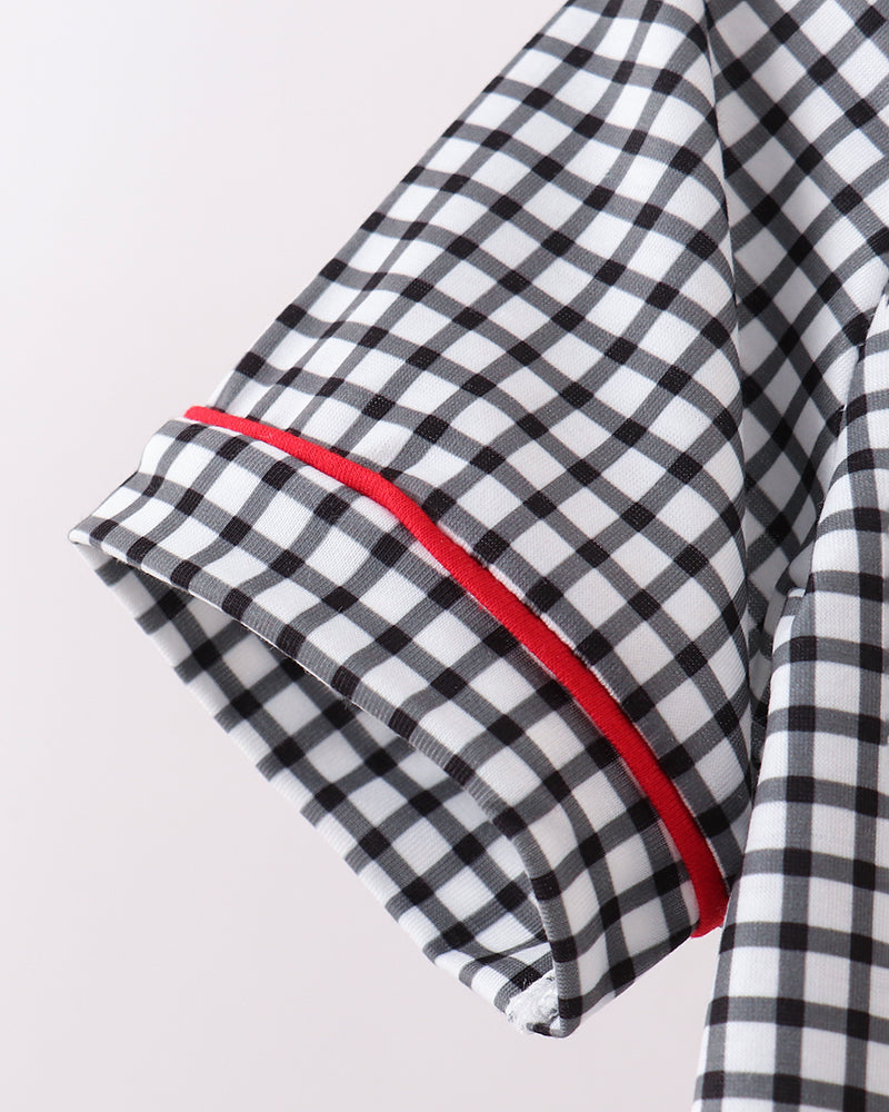 Black and white checkered fabric with red trim on a light gray background