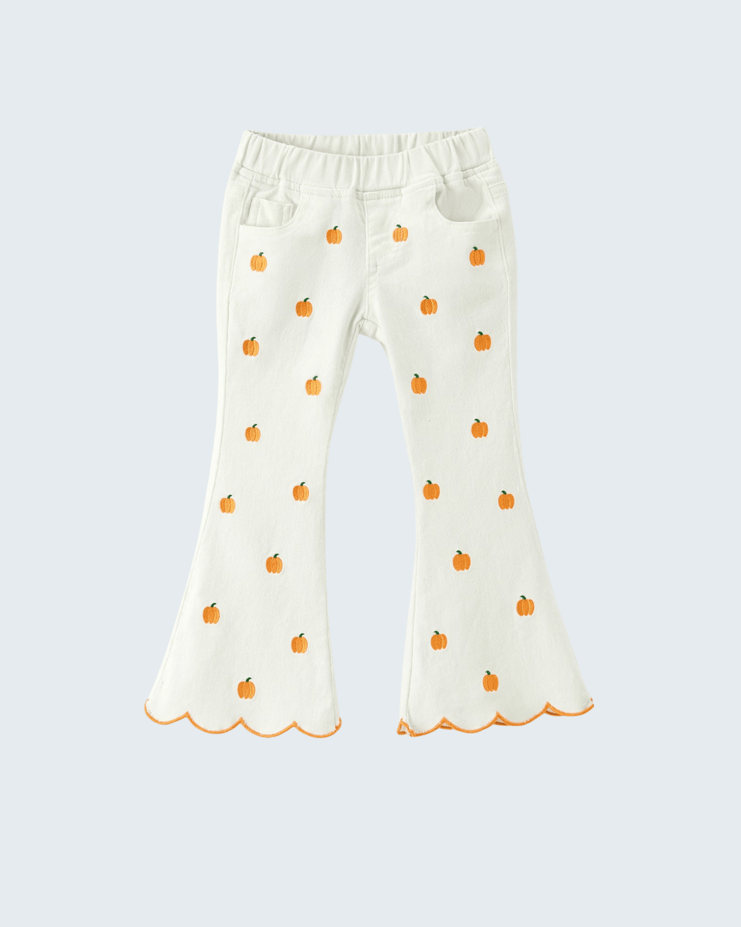 White bell-bottom pants for toddlers featuring an all-over orange pumpkin print and scalloped hems, displayed against a light gray background.