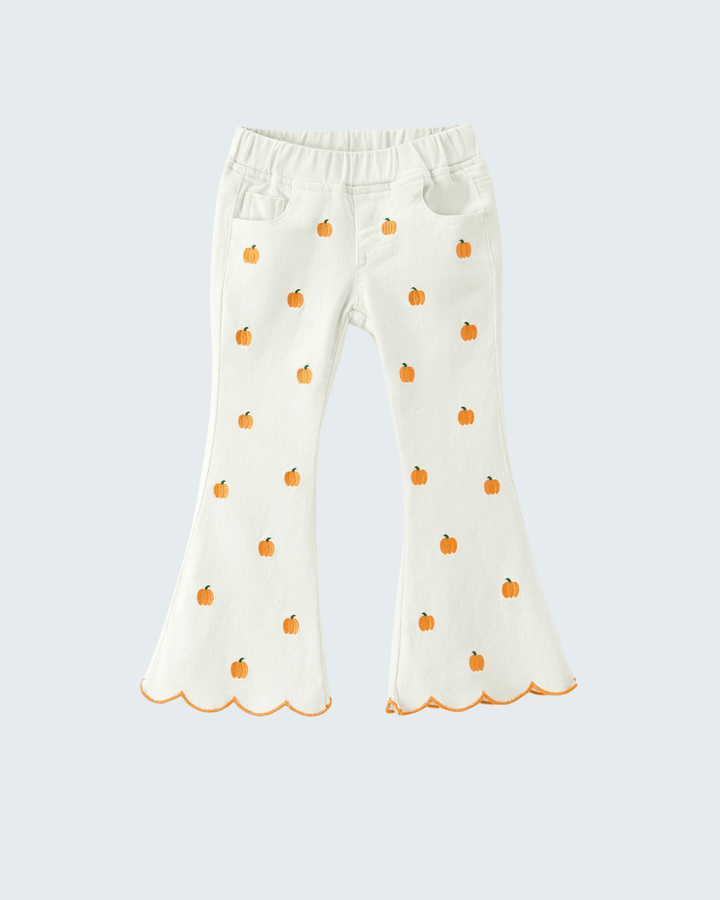 White bell-bottom pants for toddlers featuring an all-over orange pumpkin print and scalloped hems, displayed against a light gray background.