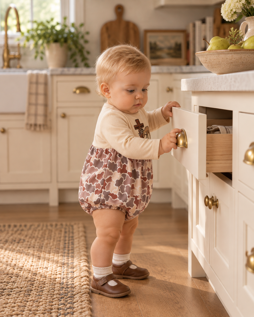 Baby boy pulling on a kitchen drawer