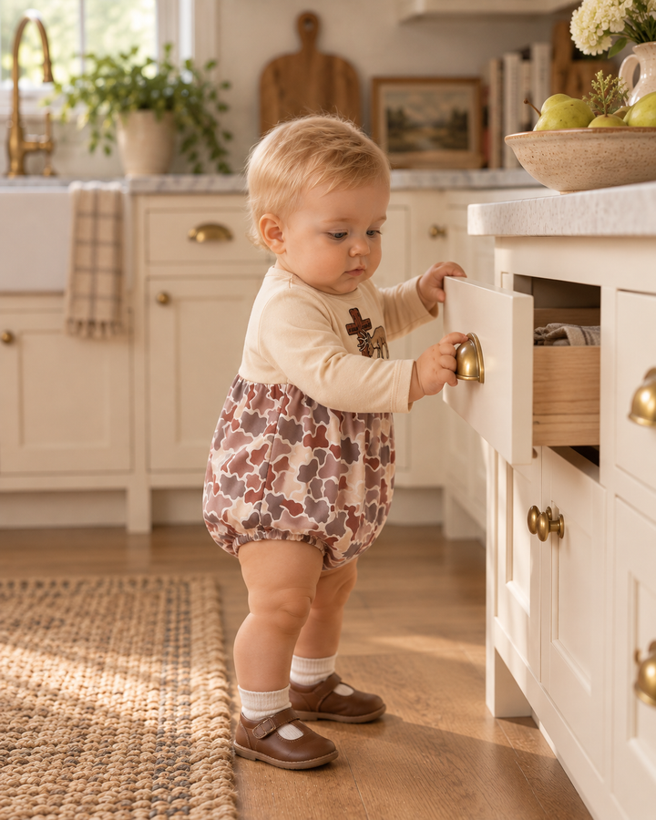 Baby boy pulling on a kitchen drawer