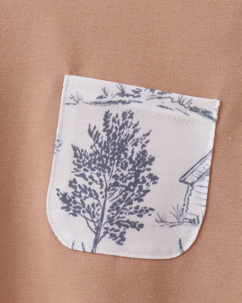 Khaki T-shirt with applique front pocket, white and blue forest print