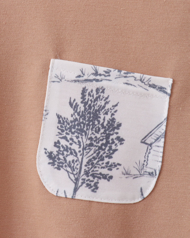 Khaki T-shirt with applique front pocket, white and blue forest print