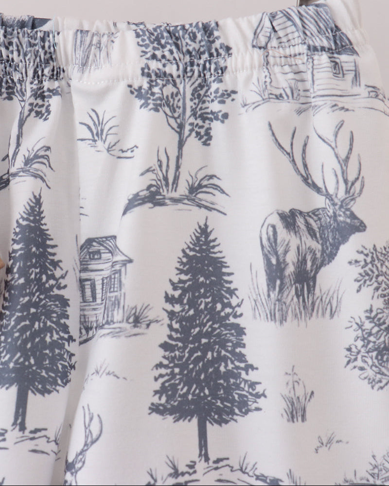 White printed shorts with blue forest scene, deer and cabin details