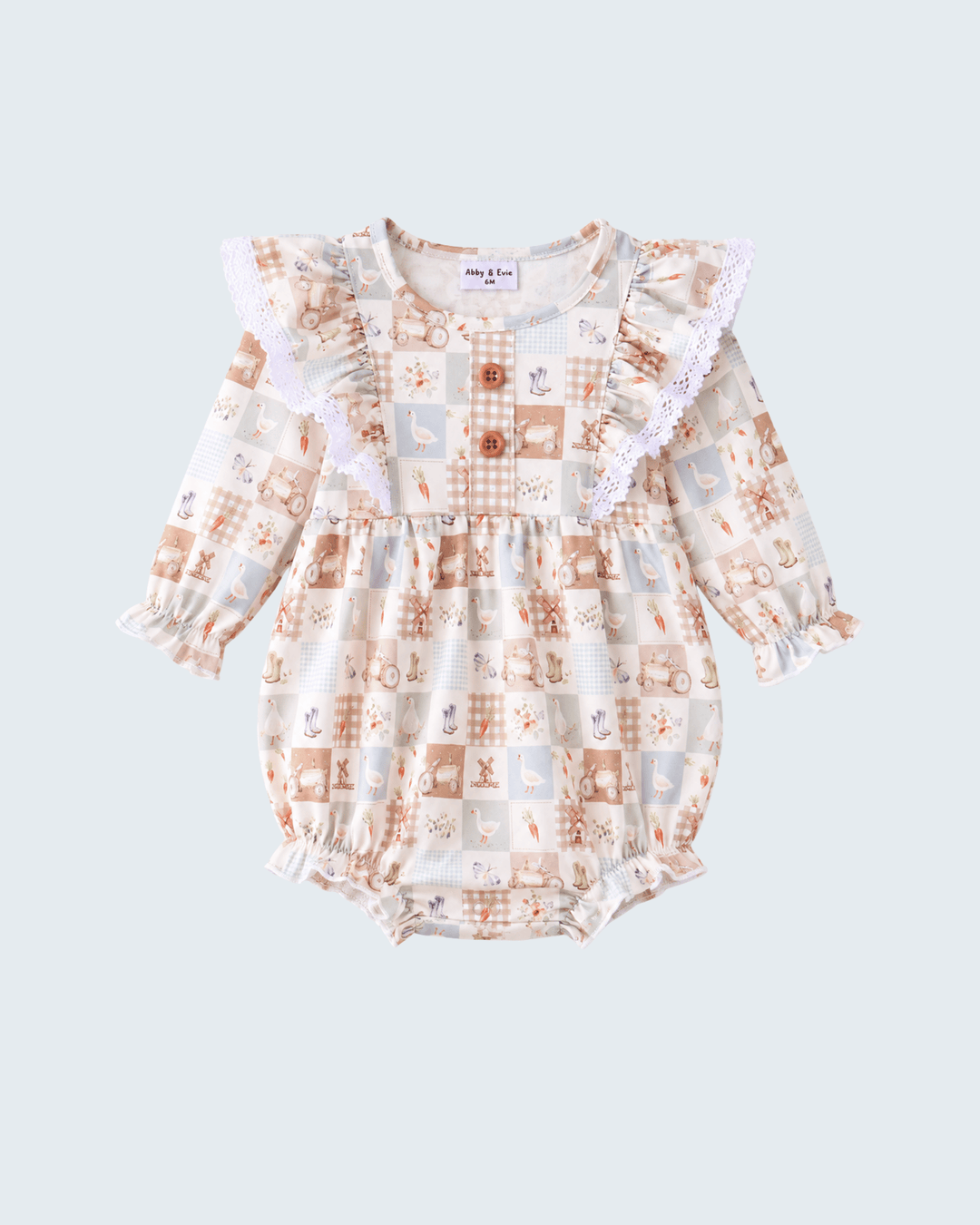 A baby long-sleeve romper with a patchwork print in beige, brown, and light blue, featuring ruffled lace shoulders and a ruffled hem, shown on a light gray background.
