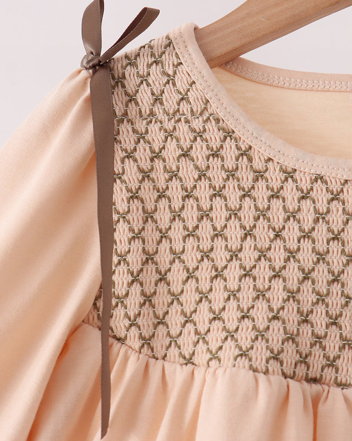 Beige smocked ruffle top with bow straps and elastic neckline