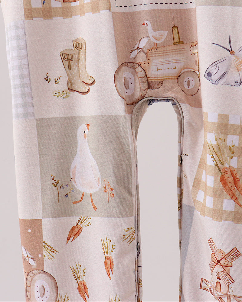 Beige printed romper legs with farm animal motifs and open pant cuffs