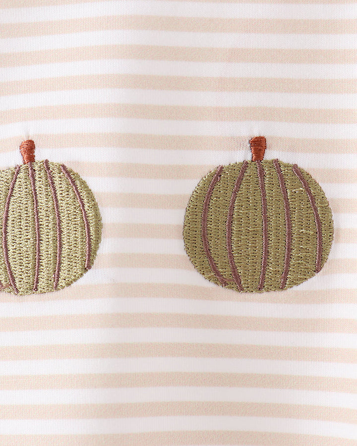 Close-up of a striped fabric garment with two embroidered pumpkin appliqués in olive green and mauve, each with a small brown stem.