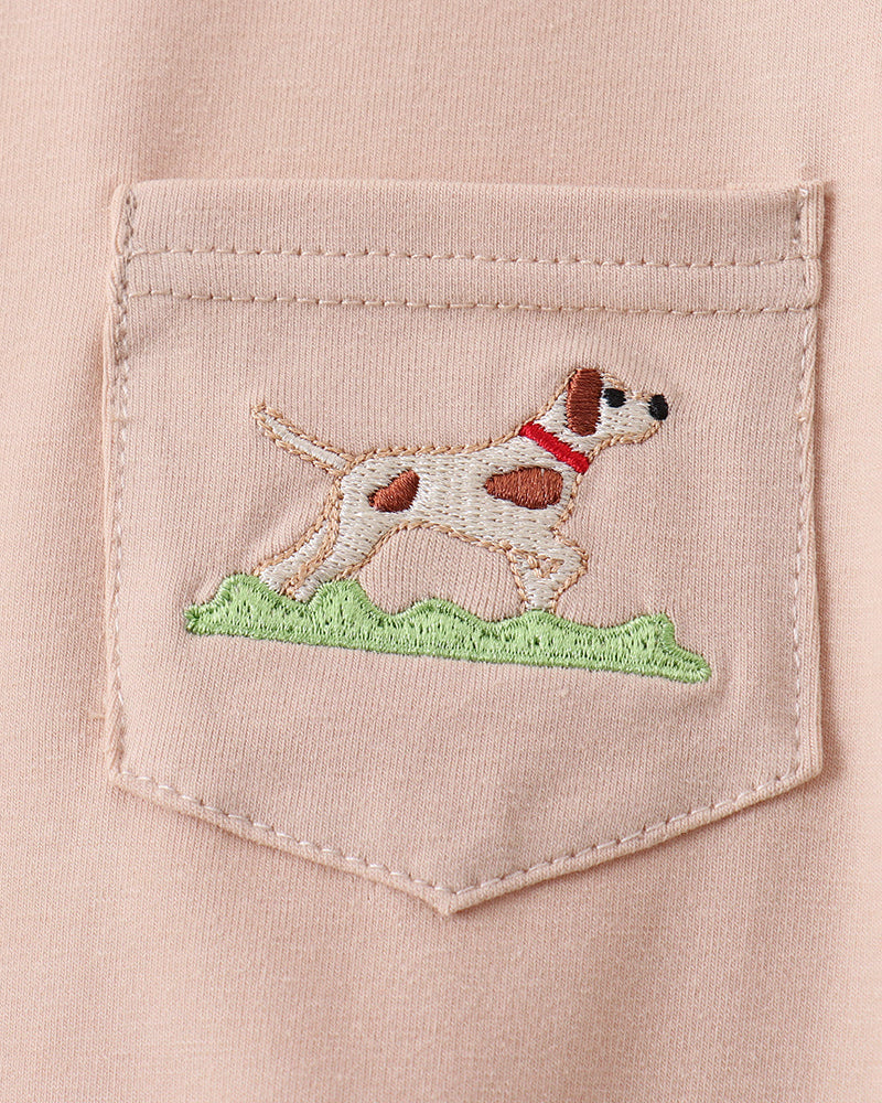 Embroidered dog design on a pocket of a light pink shirt