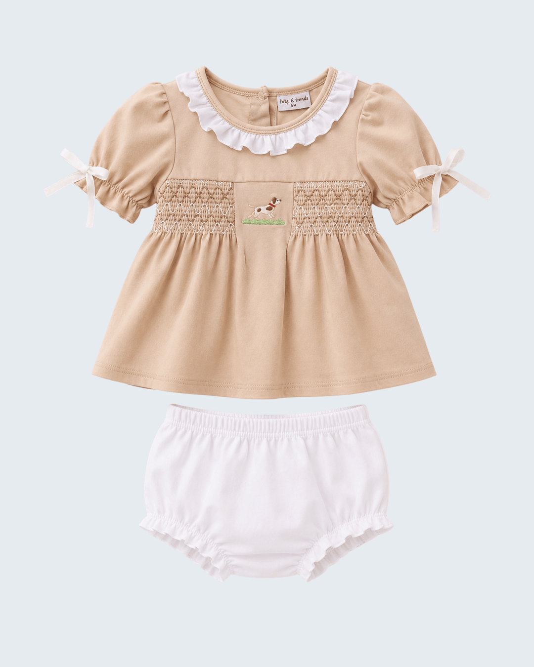 Beige top with white ruffled collar and matching bloomers on a light blue background