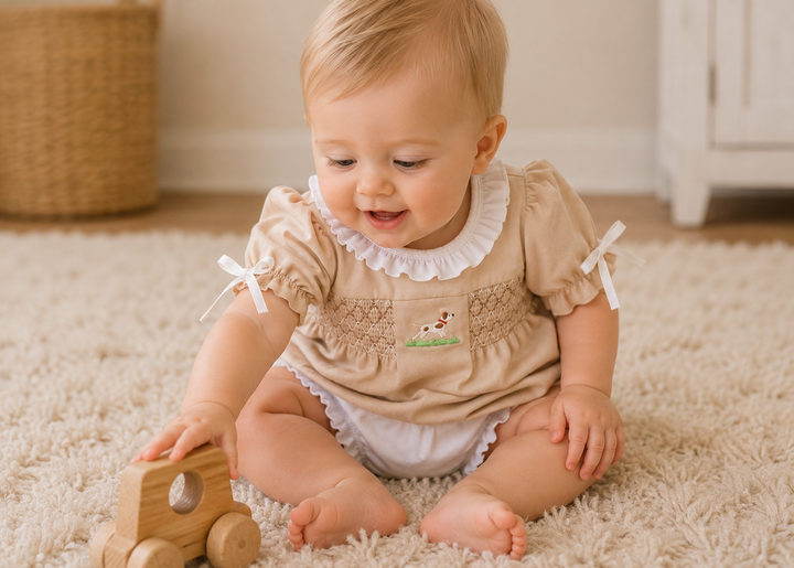 Baby sitting on a carpeted floor playing with a wooden toy car.