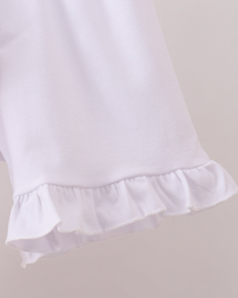 White shorts with ruffled hem on a light gray background
