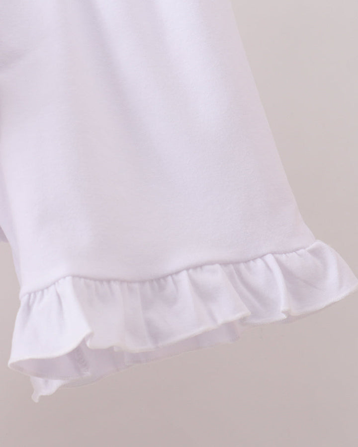 White shorts with ruffled hem on a light gray background