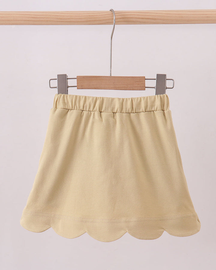 Light khaki skort with elastic waistband and scalloped hem, shown flat