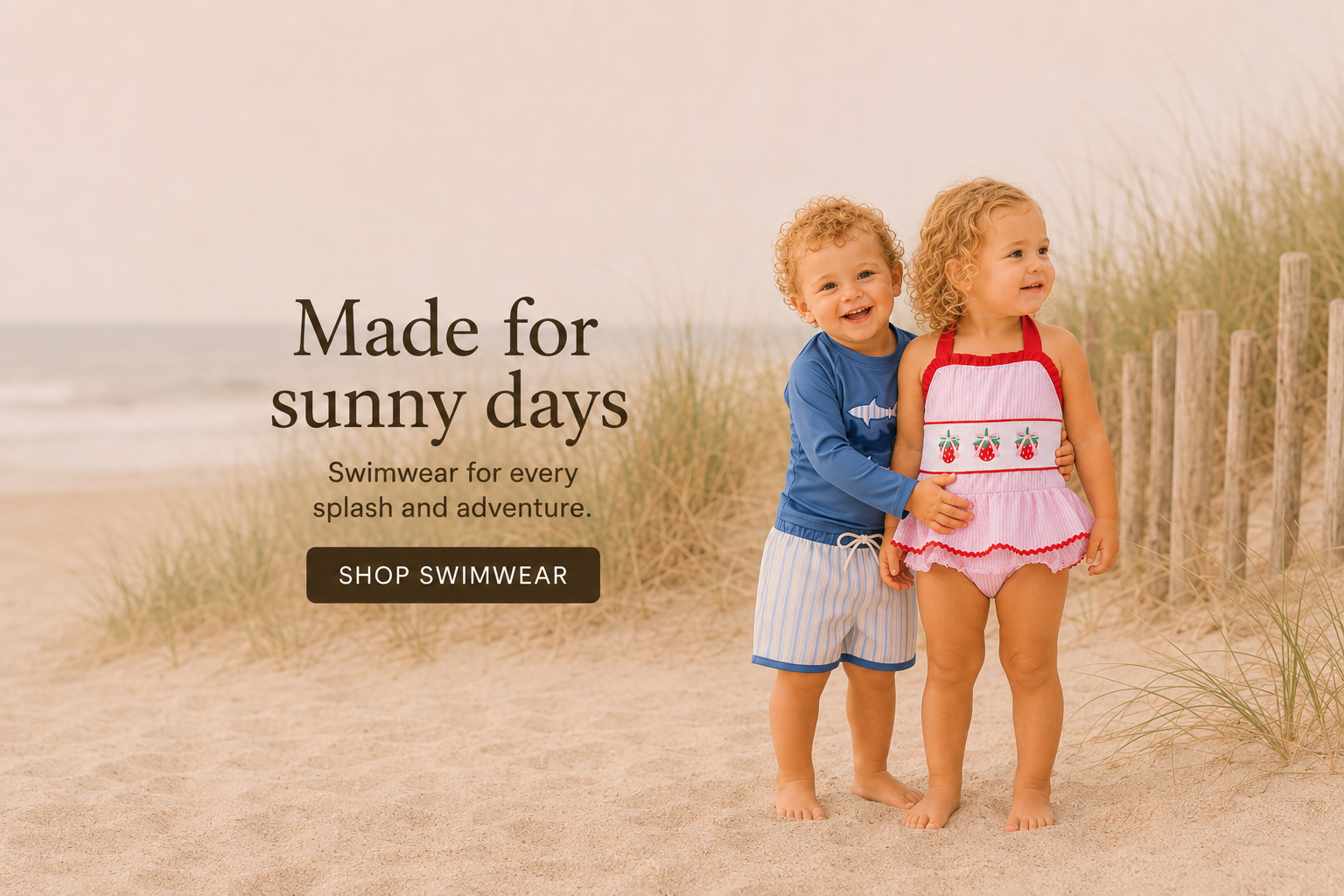Two children standing on a sandy beach with promotional text for swimwear.