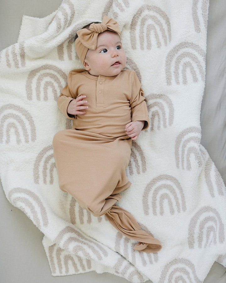 Latte tan ribbed bamboo head wrap bow knot on top worn by a baby