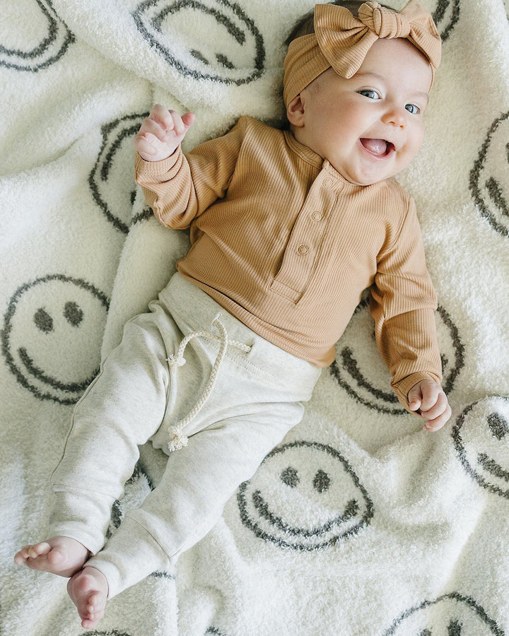 Latte tan ribbed head wrap with top bow knot, baby wearing it