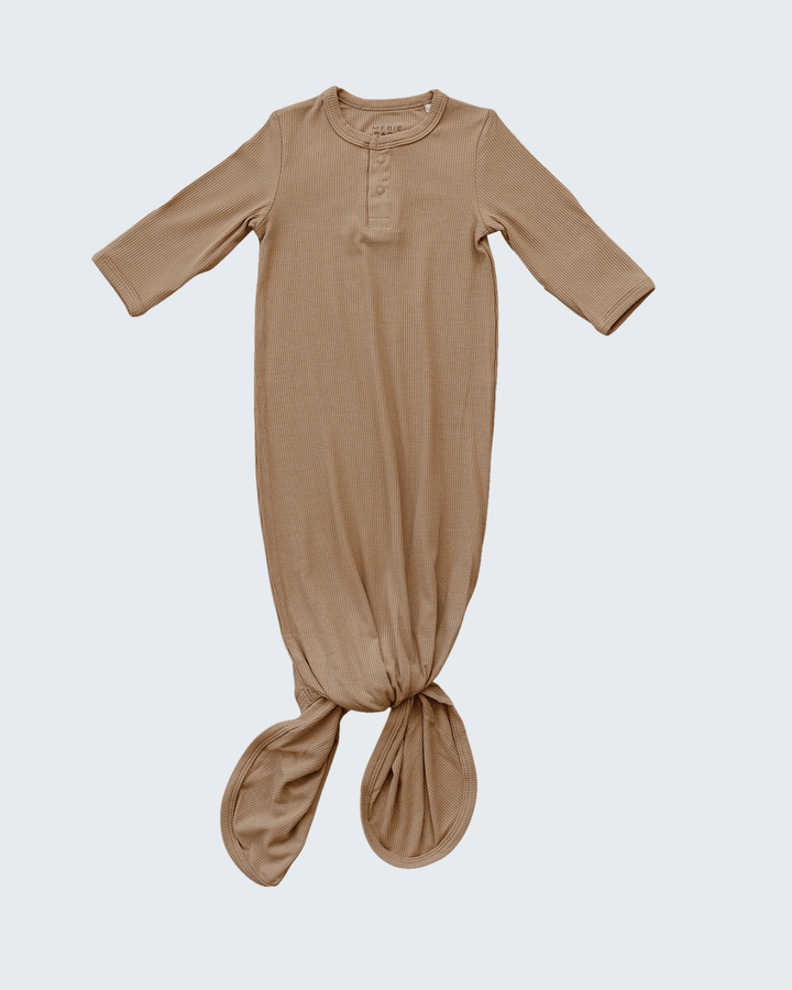 Brown baby gown on a light gray background