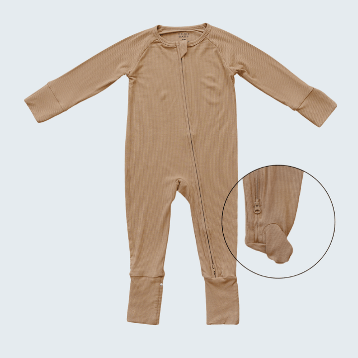 Brown baby onesie with a close-up of the foot area on a light gray background