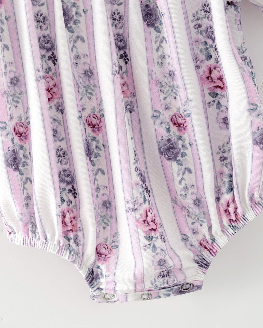 Baby girl romper close-up: lavender striped floral print with elastic leg openings