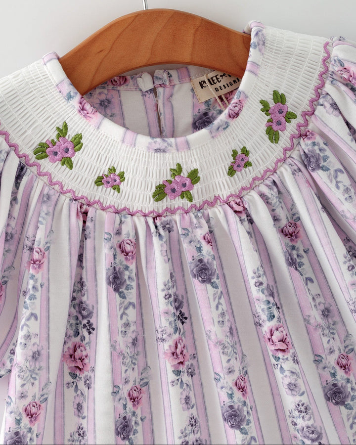 Girls smocked floral dress with embroidered green and pink flower details at neckline