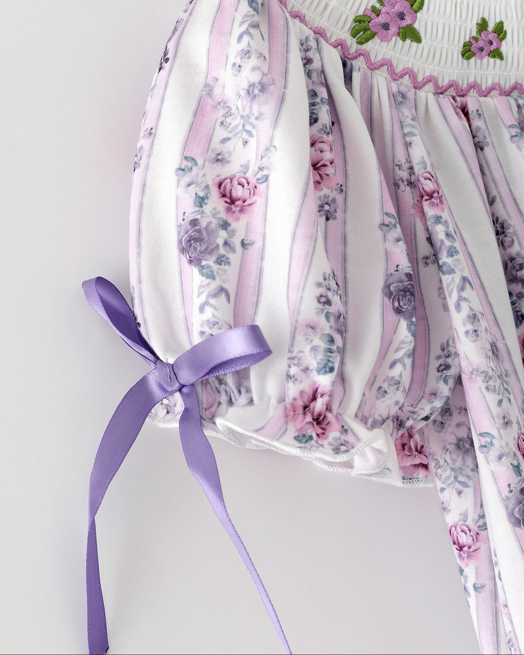 Girls floral smocked dress back with satin ribbon ties and gathered waist