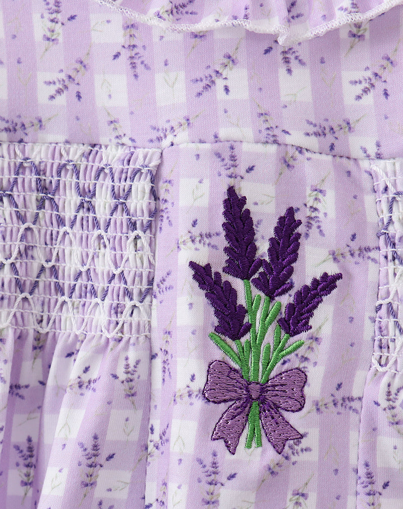 Lavender-themed dress with embroidered lavender and bow design on a matching fabric background.