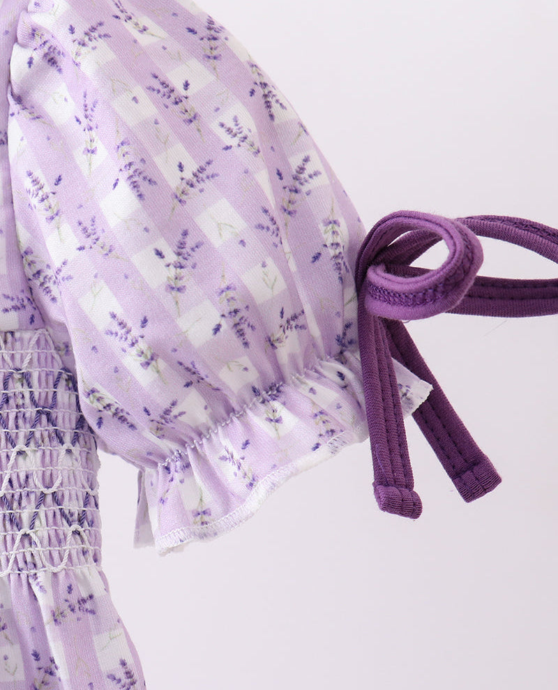 Purple floral dress with a belt on a white background