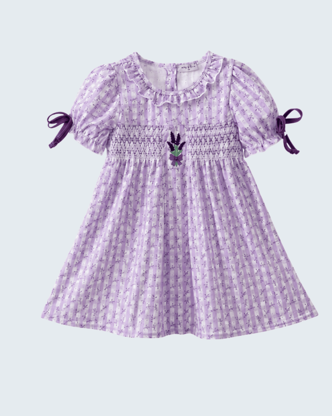 Purple checkered dress with puff sleeves and bow details on a light gray background