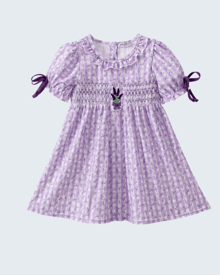 Purple checkered dress with puff sleeves and bow details on a light gray background