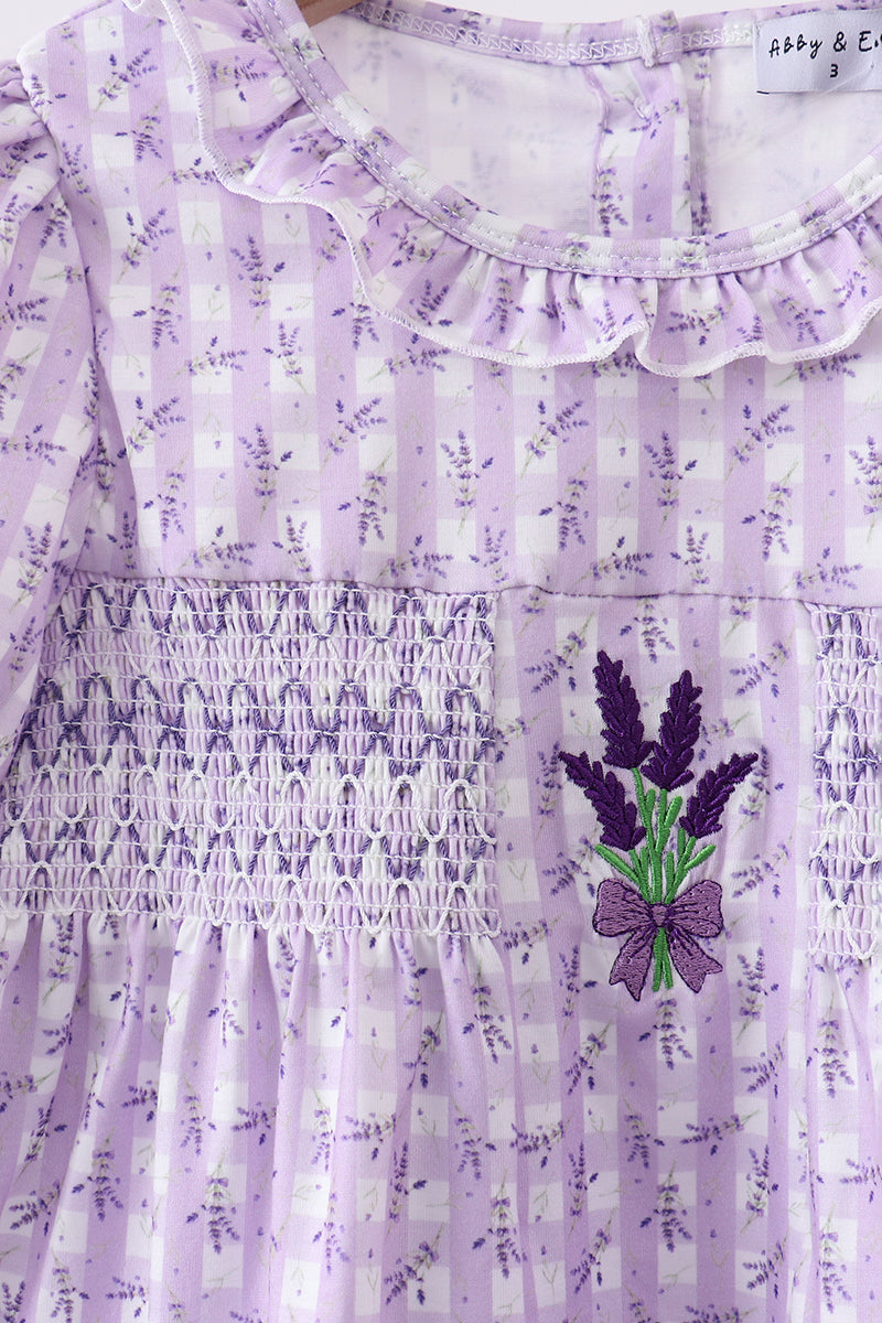 Lavender dress with floral pattern and embroidered lavender design on a white background