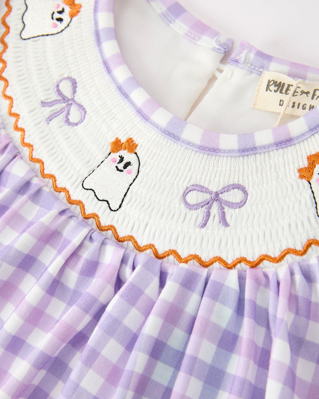 Lavender plaid girls dress with embroidered ghost faces and purple ribbon bows