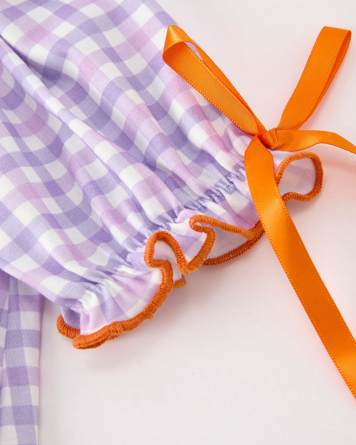 Lavender plaid dress with orange ribbon trim and bow-tied sleeve ends
