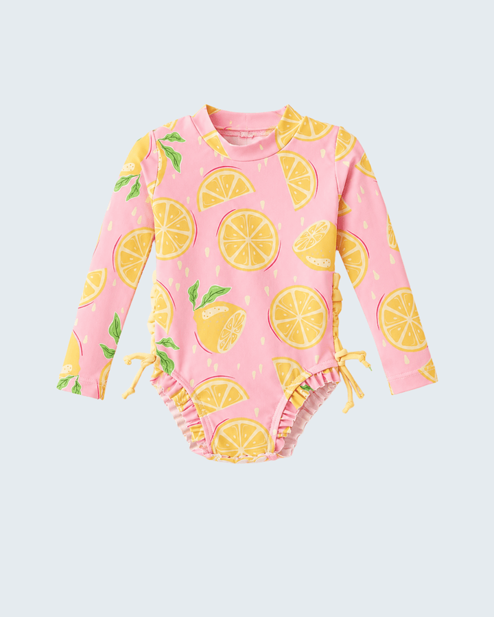 Pink baby swimsuit with lemon pattern on a light gray background