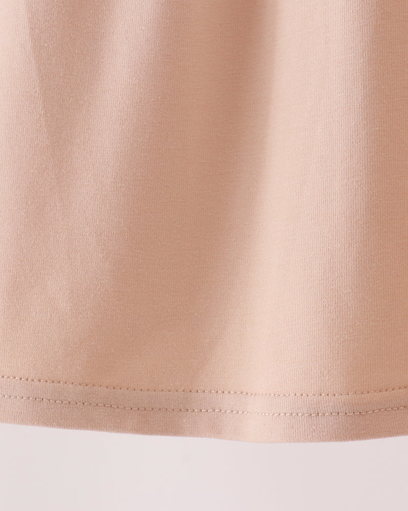 Beige A-line baby dress with gathered skirt and stitched hem