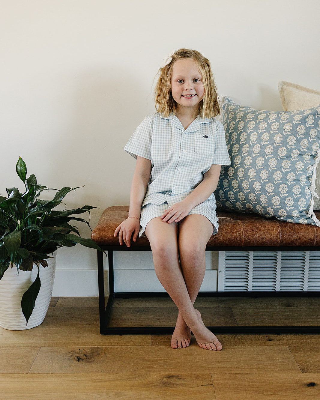 Light blue gingham short pajama set on a child, short-sleeve shirt and shorts