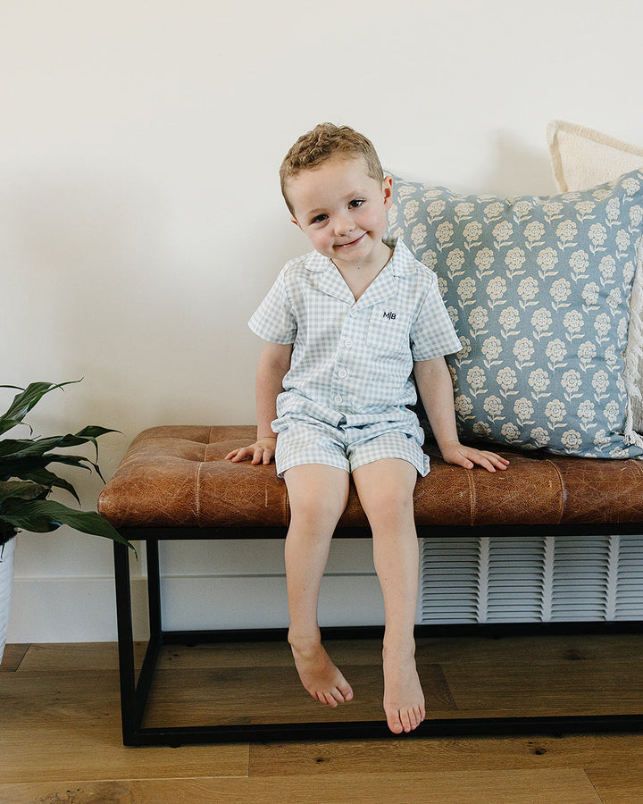 Light blue gingham short pajama set on a child, short-sleeve top and shorts
