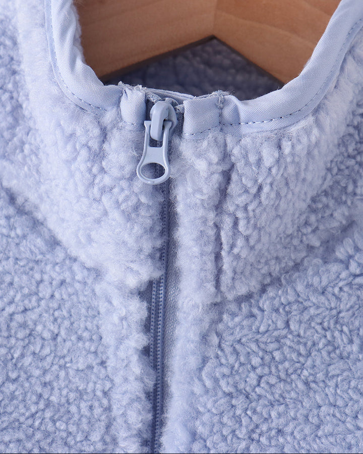 Light blue fleece jacket close-up showing front zipper pull