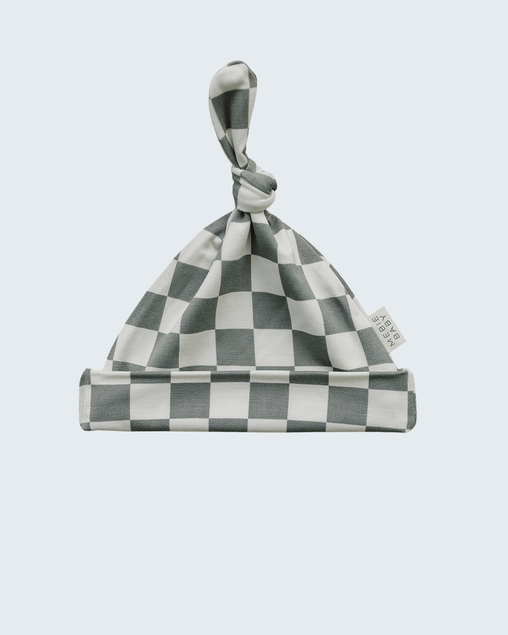 Checkered baby hat on a light blue background
