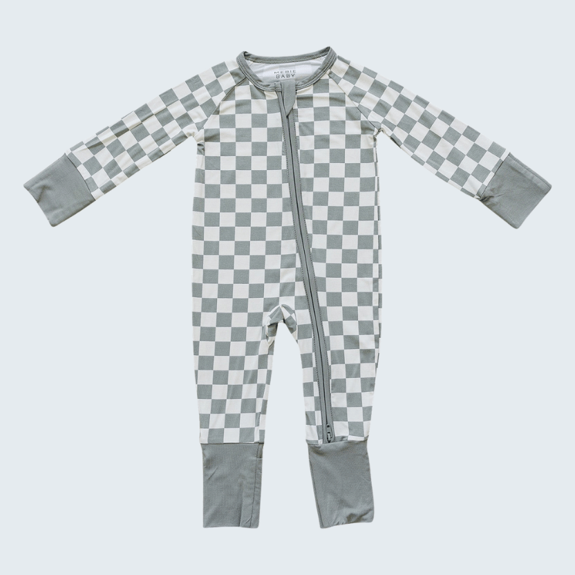 Checkered baby onesie with gray and white pattern on a light gray background