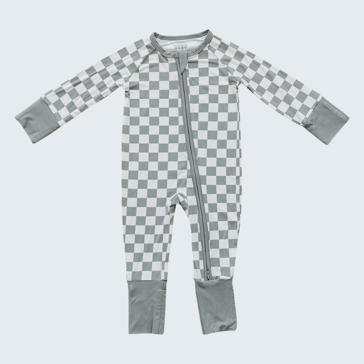 Checkered baby onesie with gray and white pattern on a light gray background