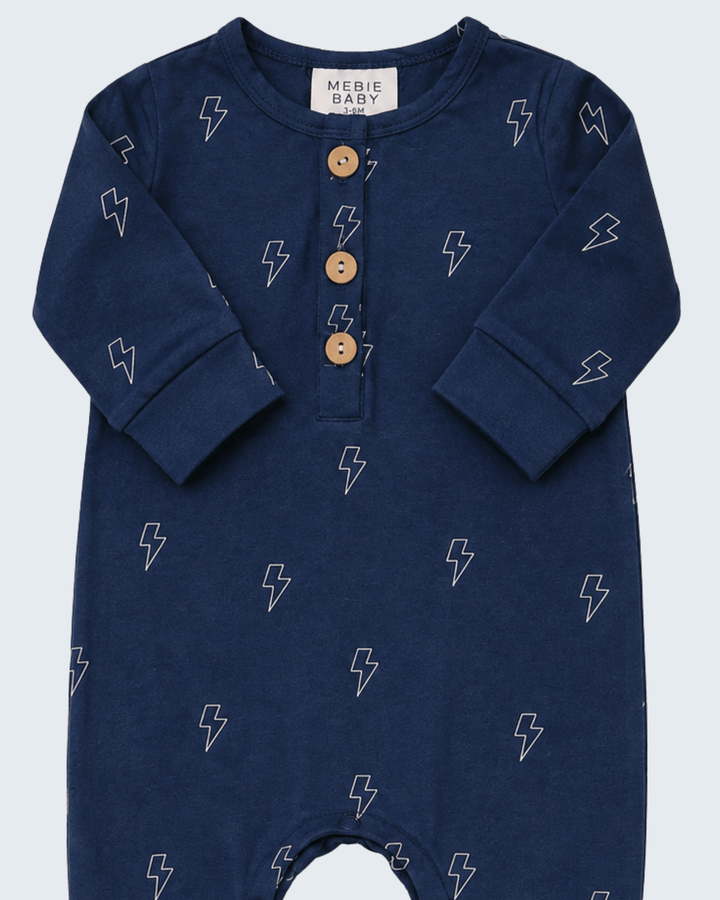 Navy lightning-print romper with long sleeves and three-button henley placket