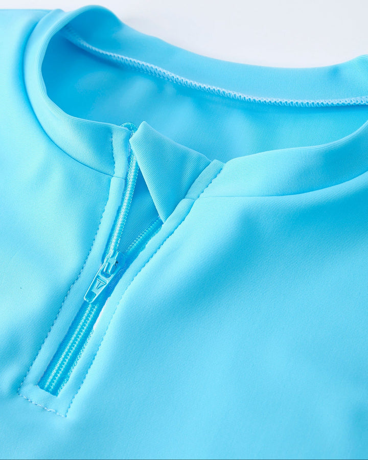 Close-up of a light blue garment with a zipper on a white background