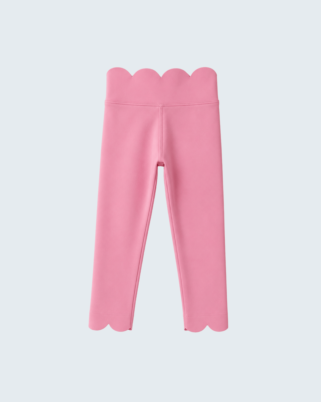Pink leggings with scalloped edges on a light gray background