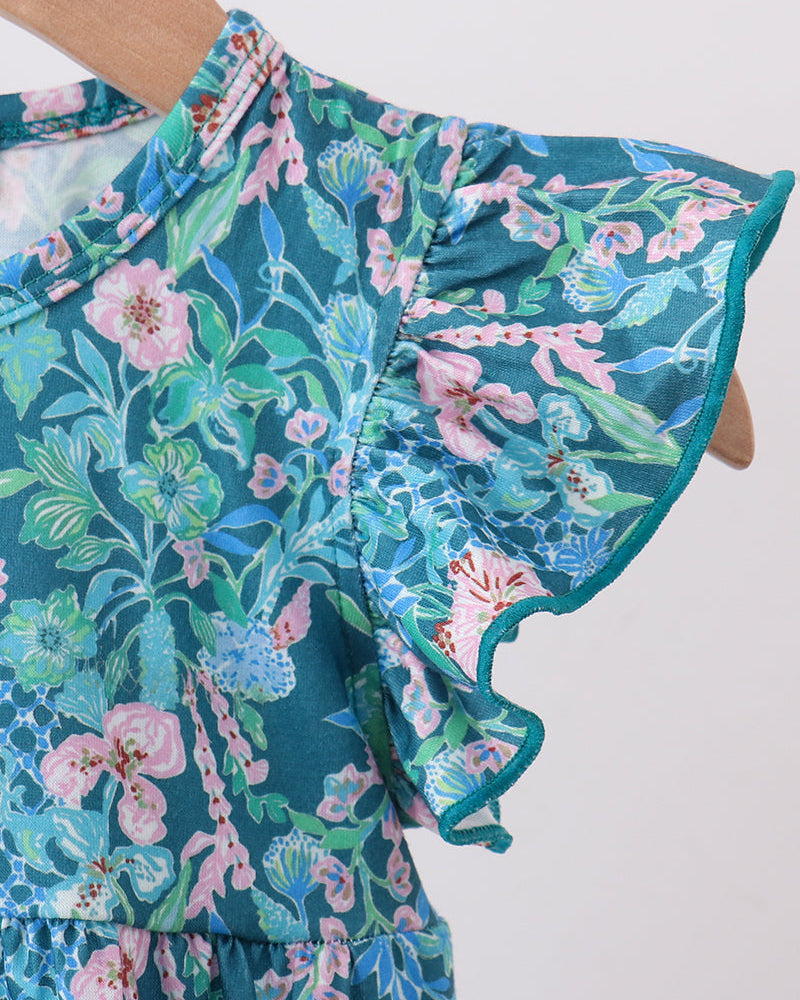 Floral bubble romper close-up: teal fabric with pink flowers, flutter sleeve with tie