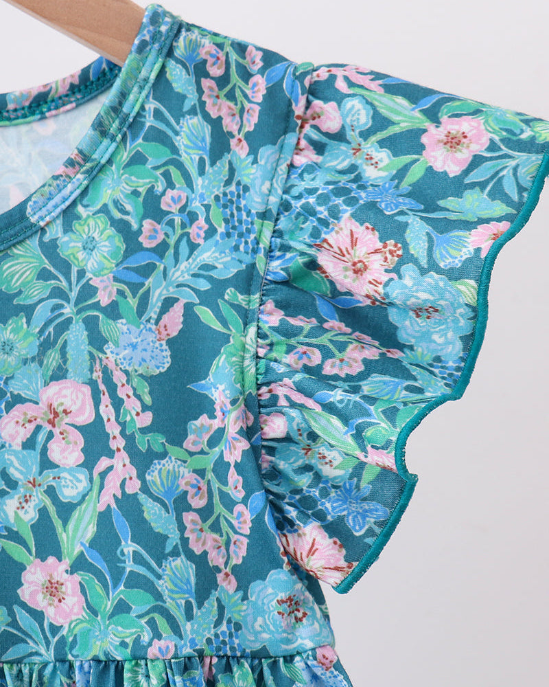 Lily floral dress close-up: teal fabric with pink floral pattern, gathered shoulder ruffle