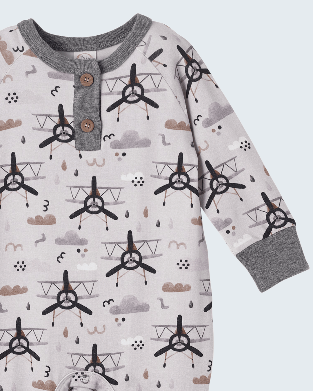 Long-sleeve baby henley romper in white with gray collar and dark airplane print