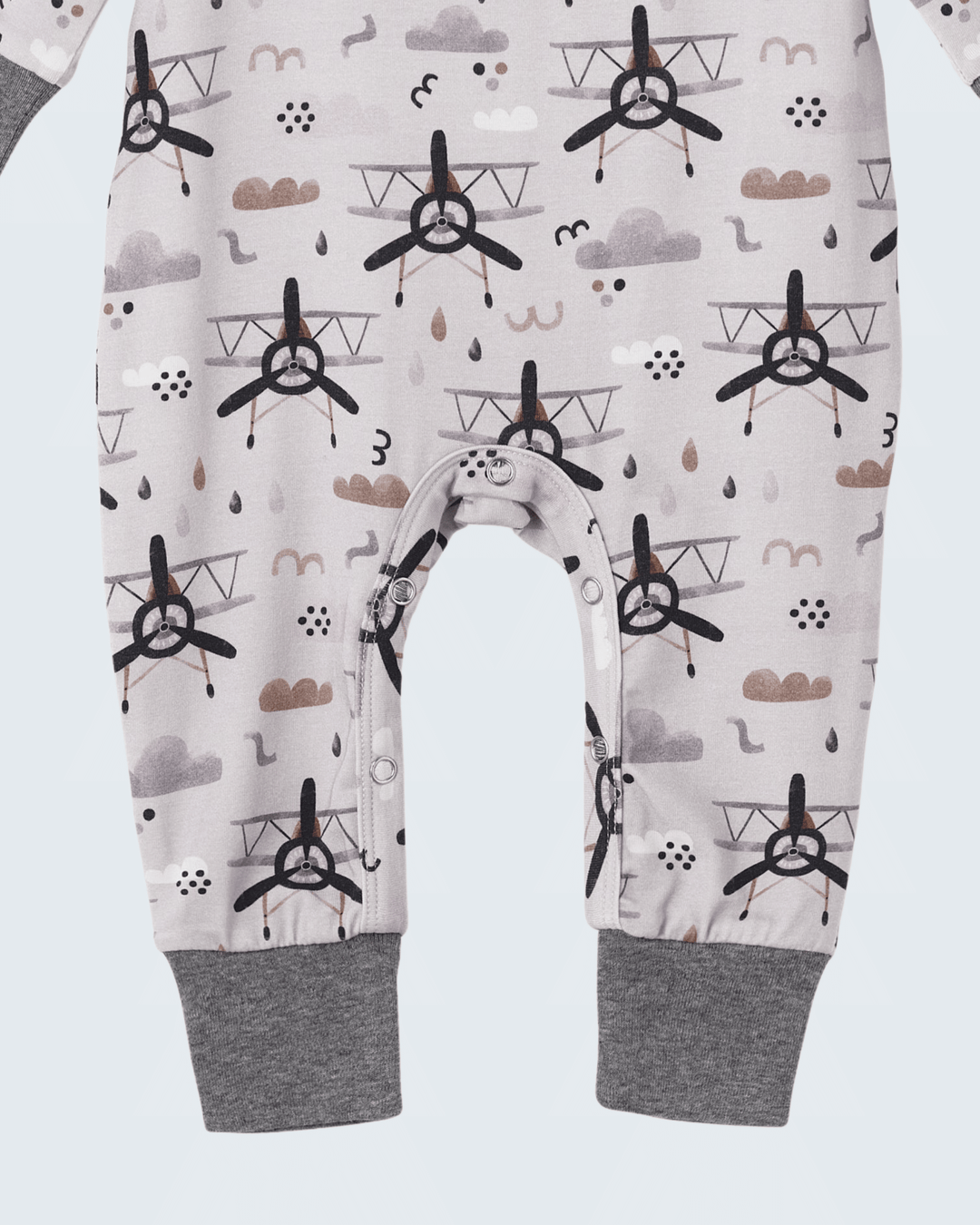 Baby romper with airplane pattern and gray foot cuffs, crotch snap with bear-face patch
