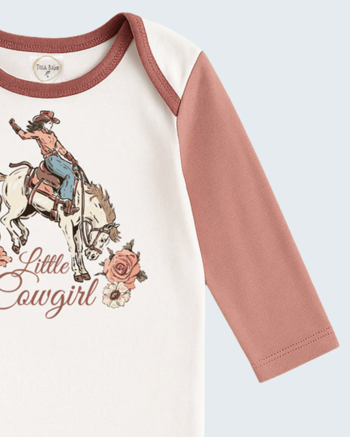 Baby cotton rib bodysuit close-up: cream body, dusty rose sleeve, cowgirl print